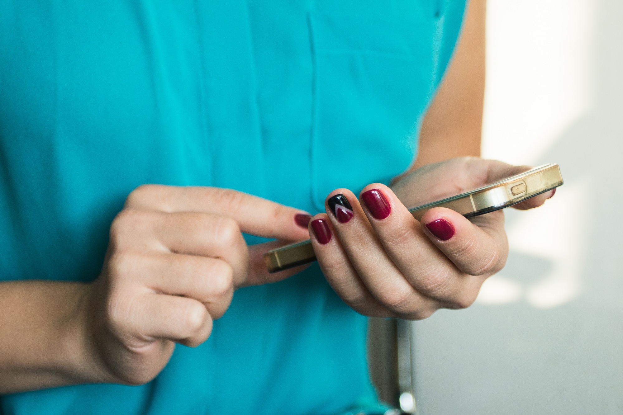 Close up of young woman handing smartphone.