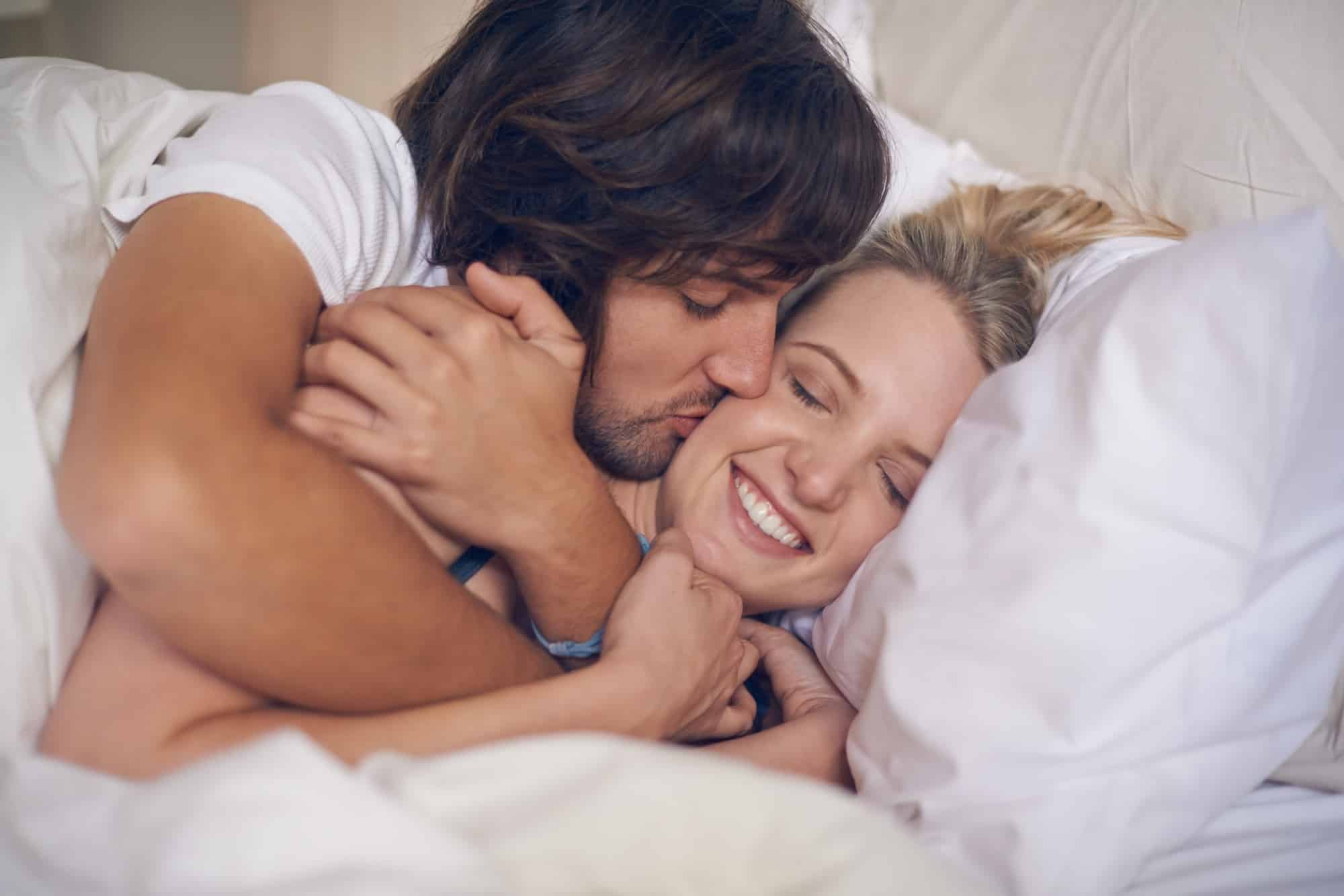 Goodnight kisses. Cropped shot of a couple showing affection in bed.