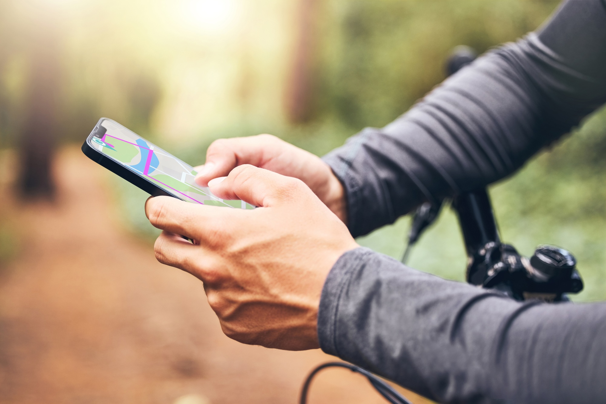 Gps, map and cyclist with smartphone for digital travel guidance in nature fitness trail. Mobile te
