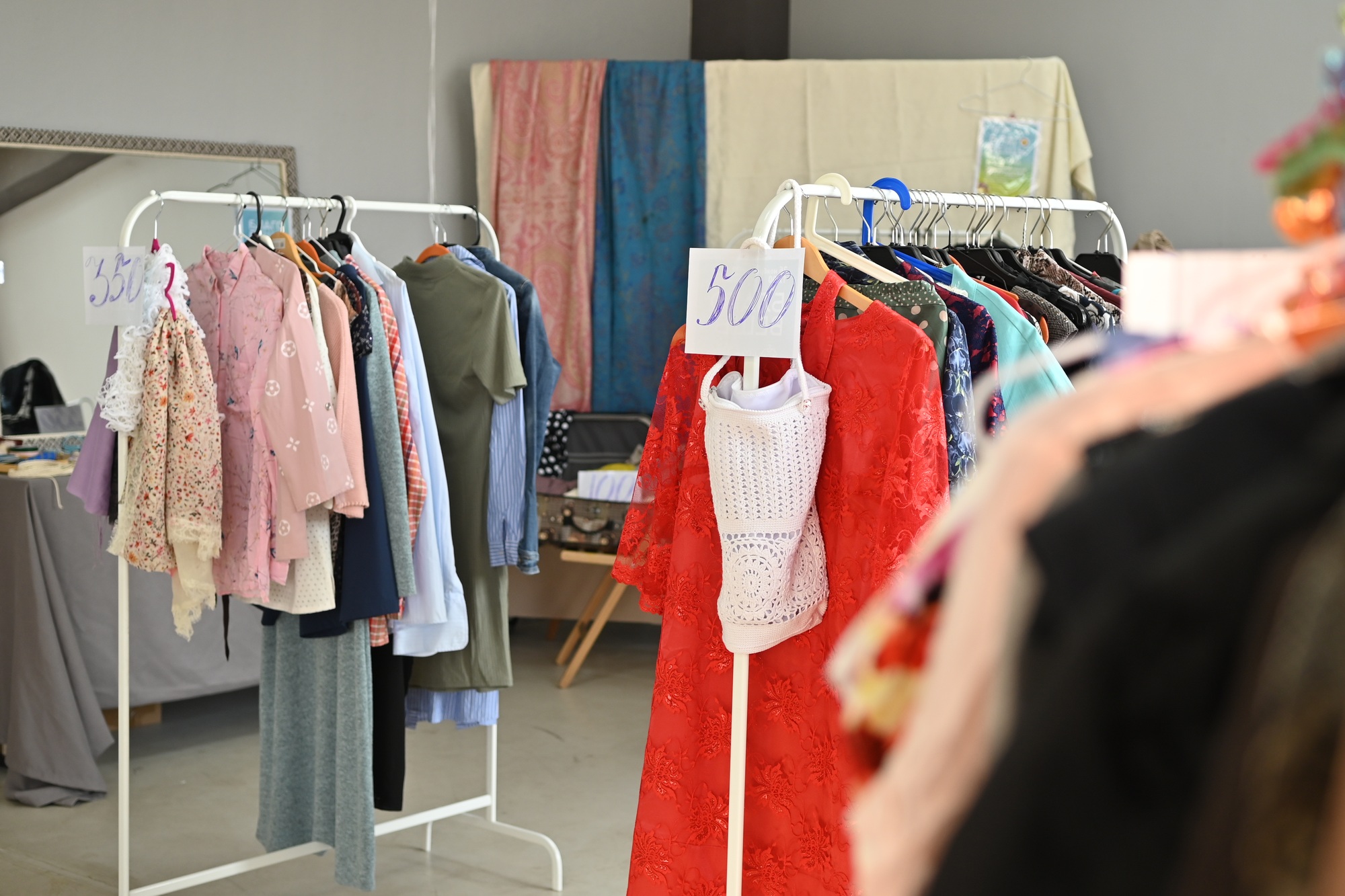 Stylish clothing items displayed on racks at a trendy store during a special sale event